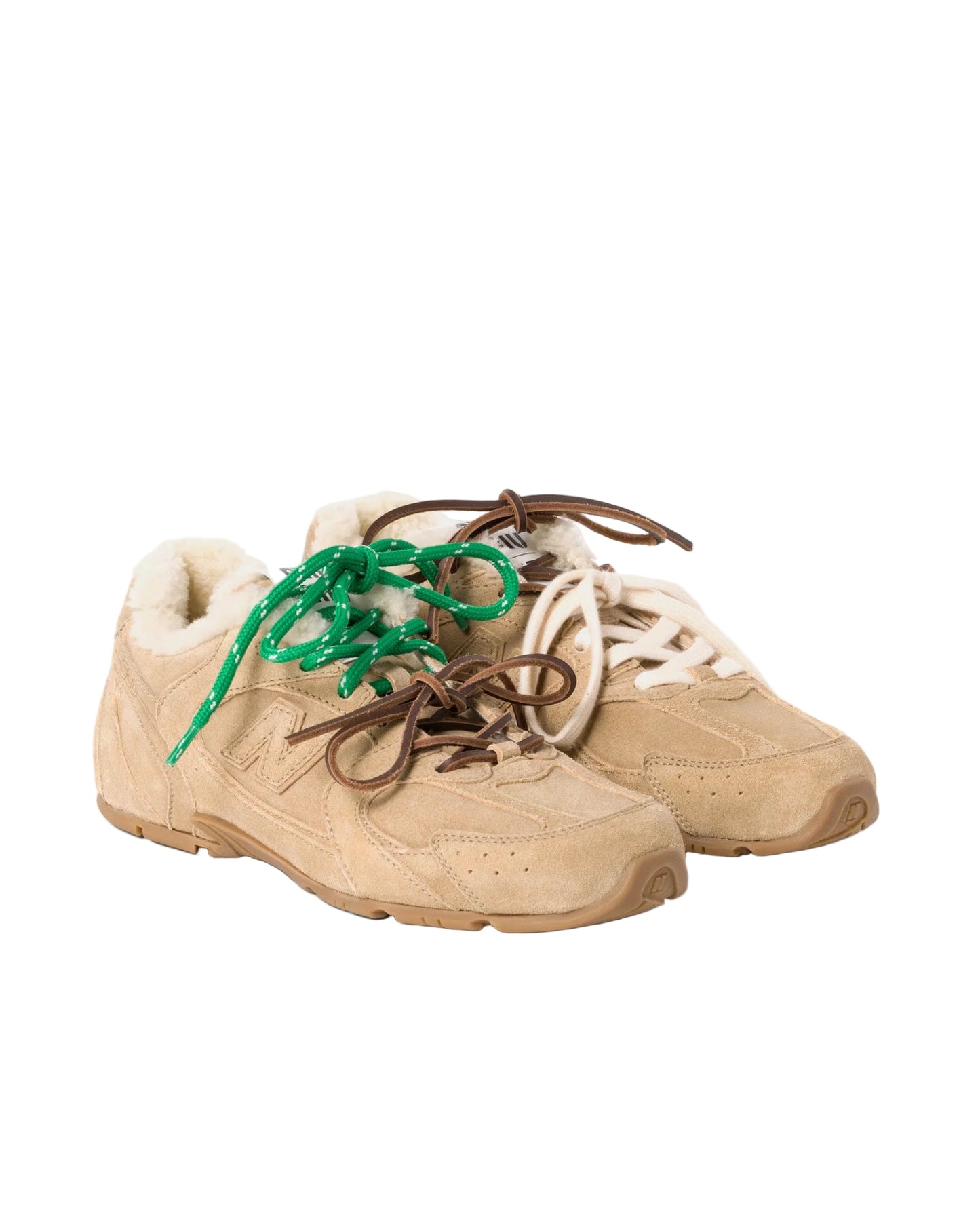 Beige sneakers with green and brown laces on a white background
