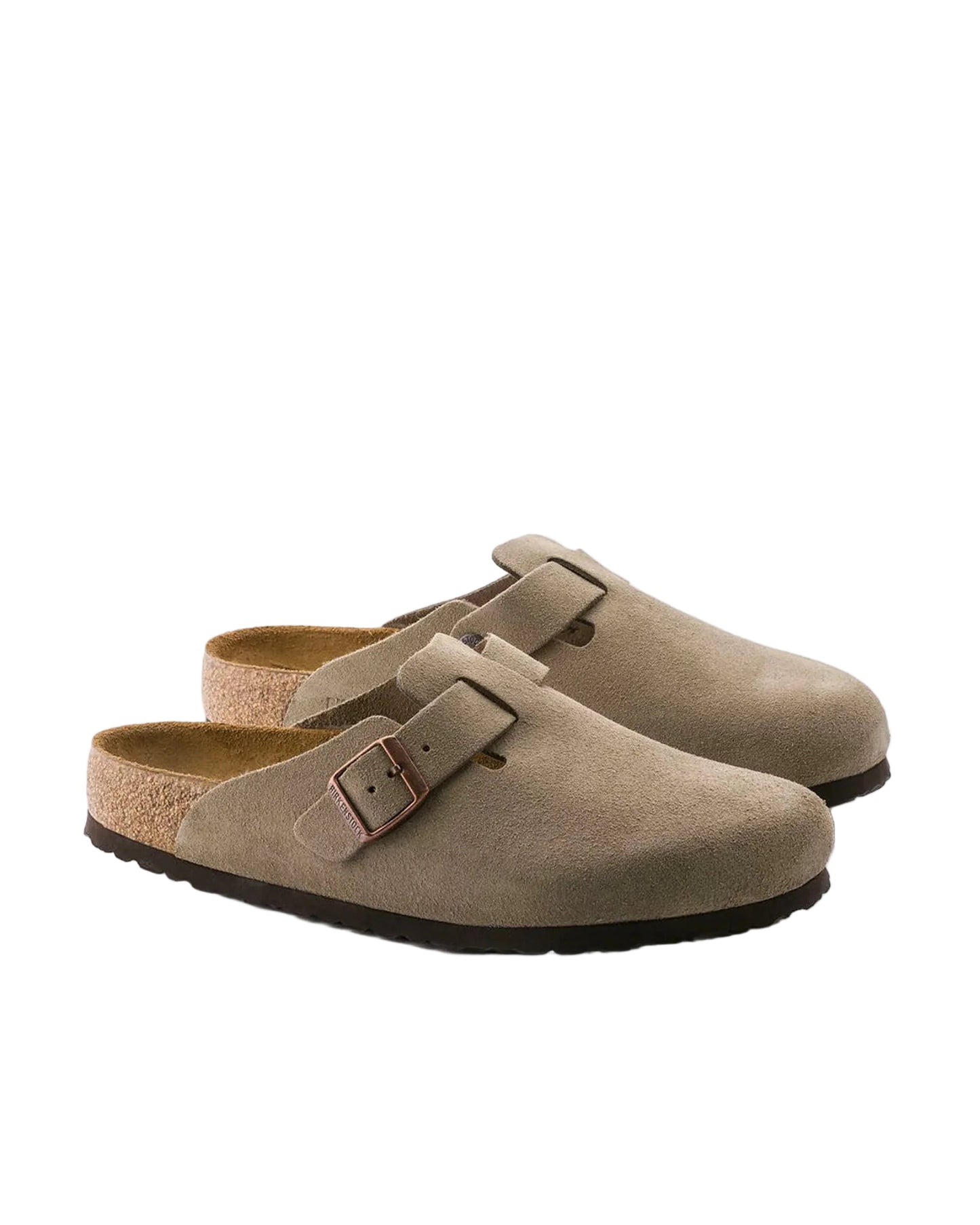 Pair of brown suede clogs with a buckle on a white background