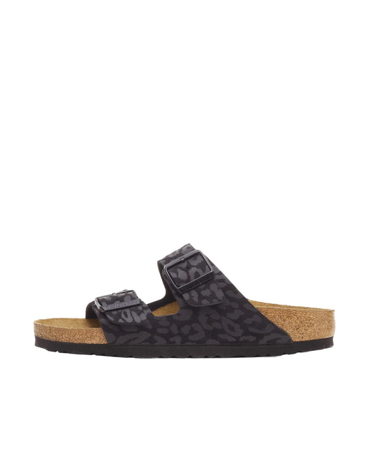 Black sandal with brown sole on a white background
