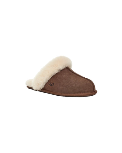 Brown slipper with white fur lining on a light gray background