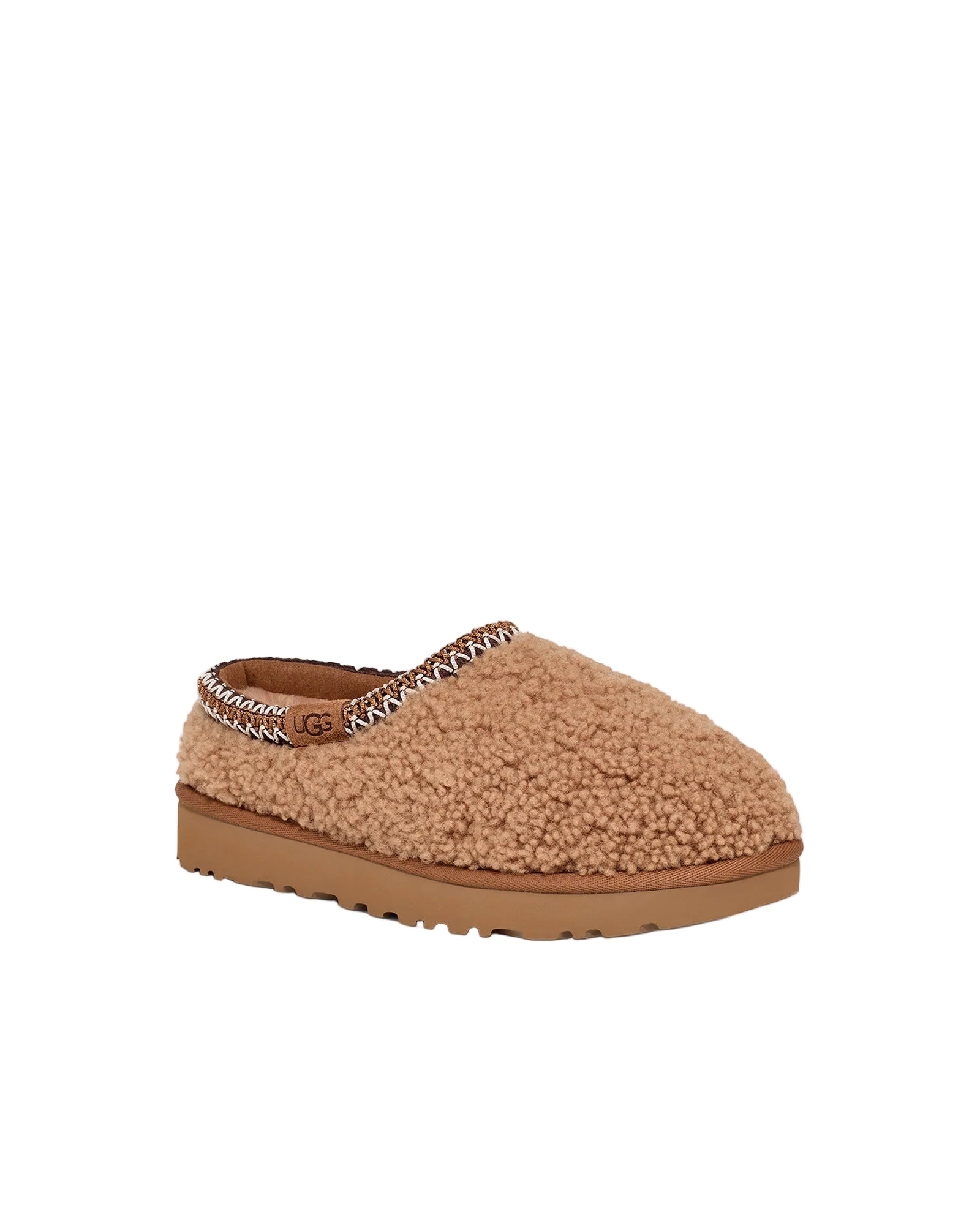 Brown slipper with a textured sole on a white background