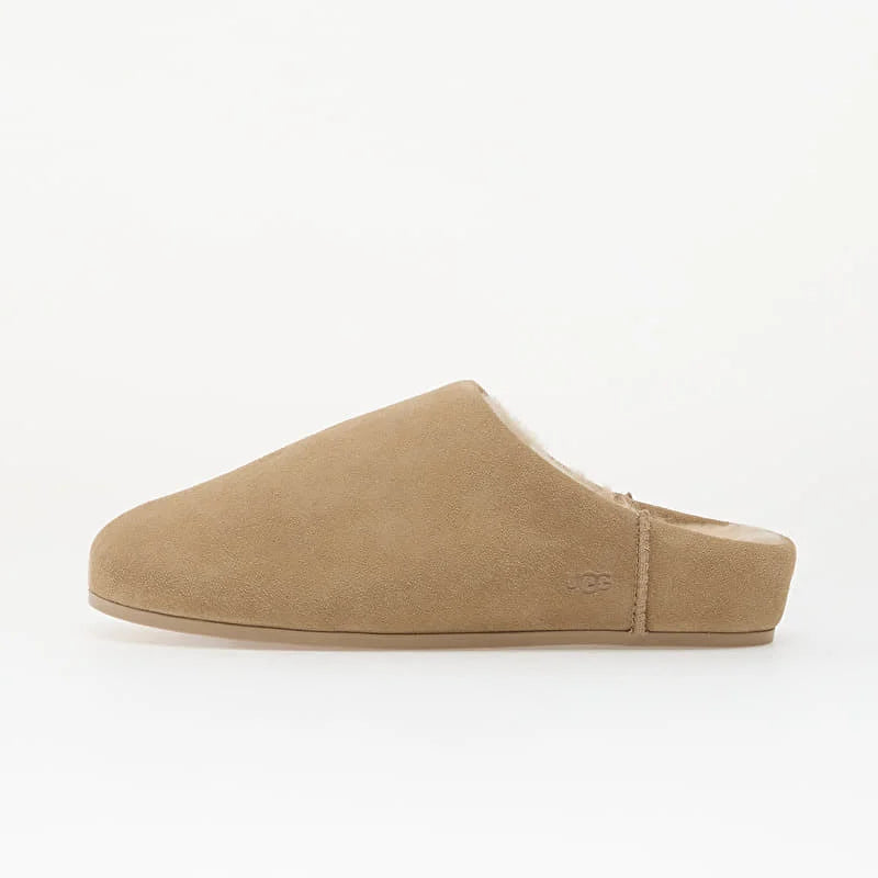 A single UGG slip-on mule slipper in tan suede with a soft cream shearling lining, shown from the side against a plain white background.
