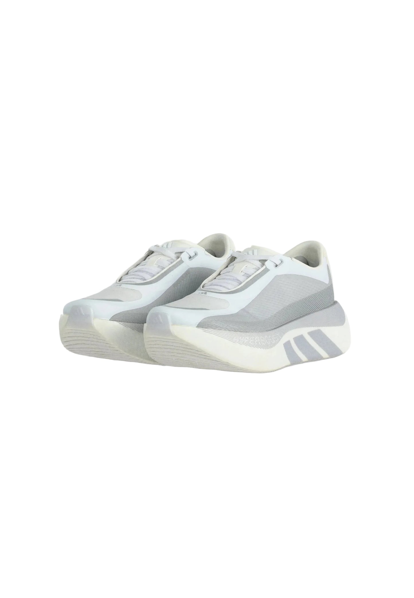 A pair of low-top sneakers in light gray and white, featuring a chunky sole with a side stripe detail, photographed on a light gray background.