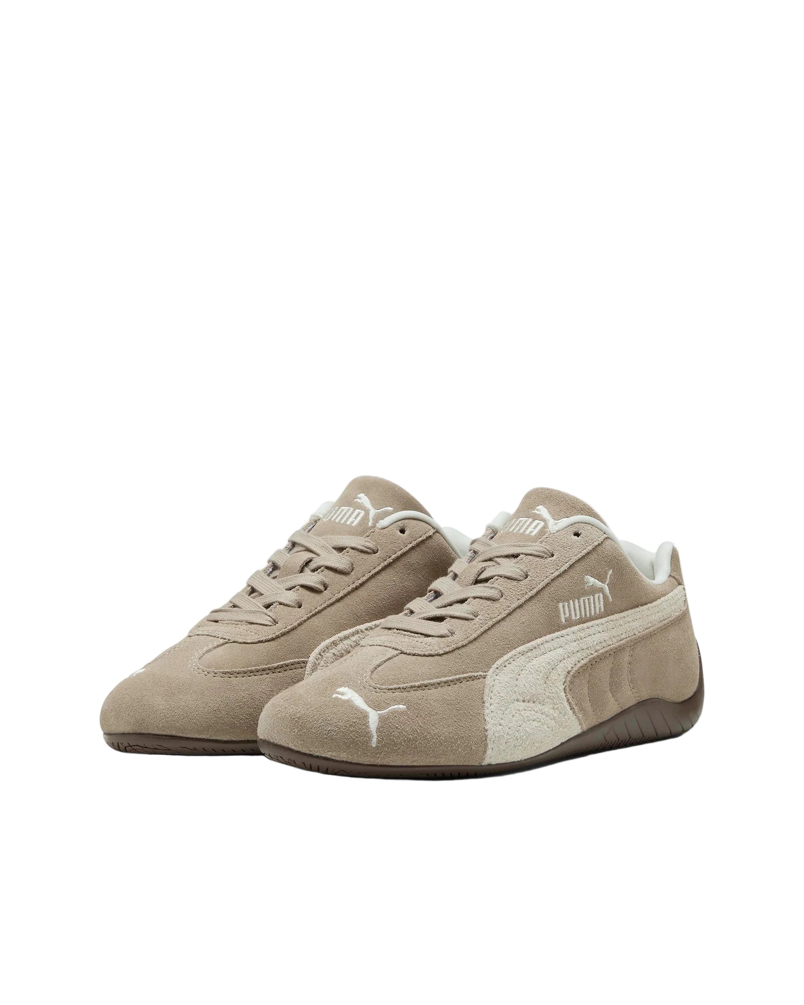 Pair of beige Puma sneakers on a white background