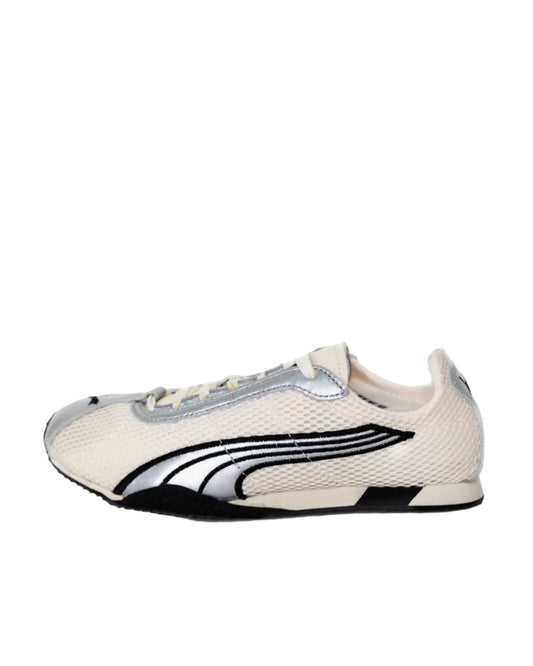 White sneaker with black and gray accents on a white background