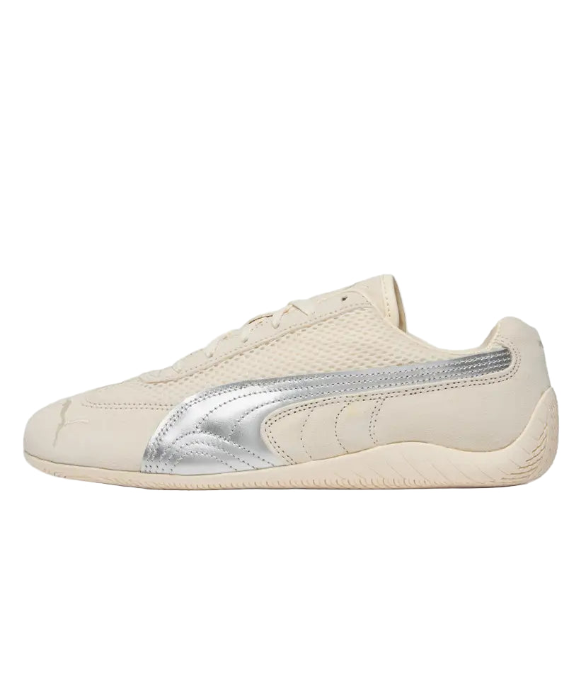 Beige sneaker with silver accents on a white background