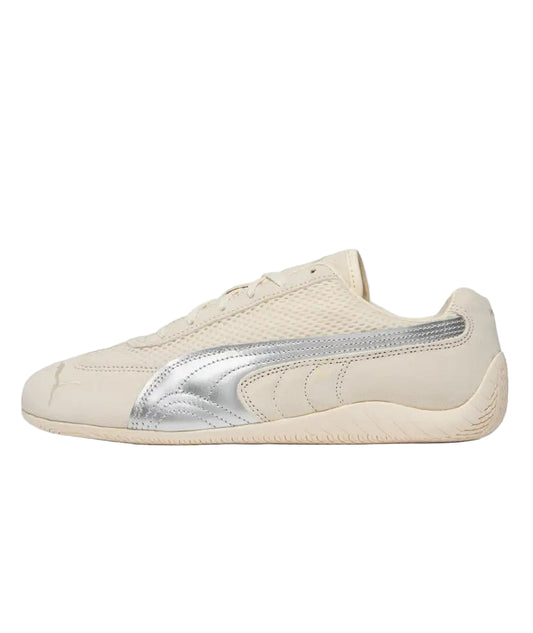 Beige sneaker with silver accents on a white background