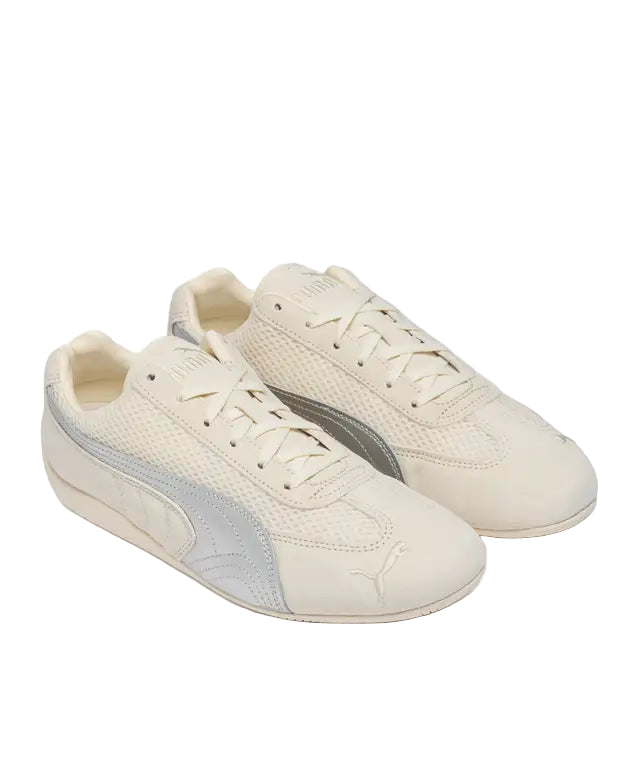 Pair of beige sneakers with gray accents on a white background
