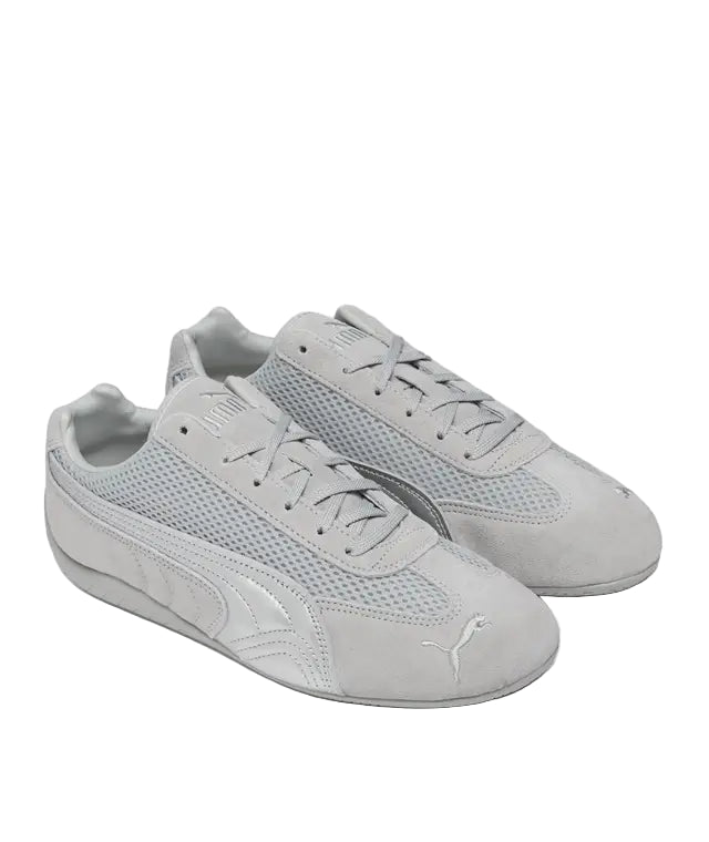 Pair of gray sneakers with a brand logo on a white background