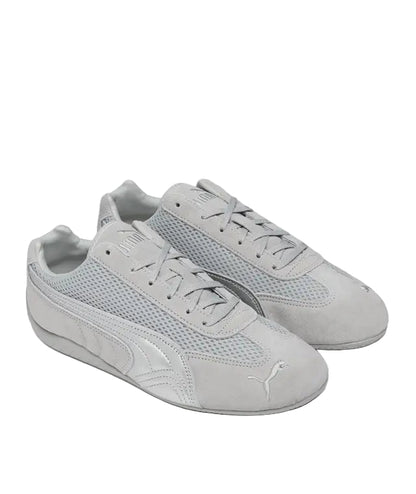 Pair of gray sneakers with a brand logo on a white background