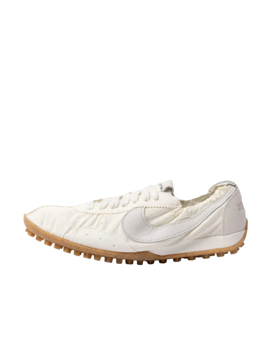 White sneaker with a brown sole on a white background