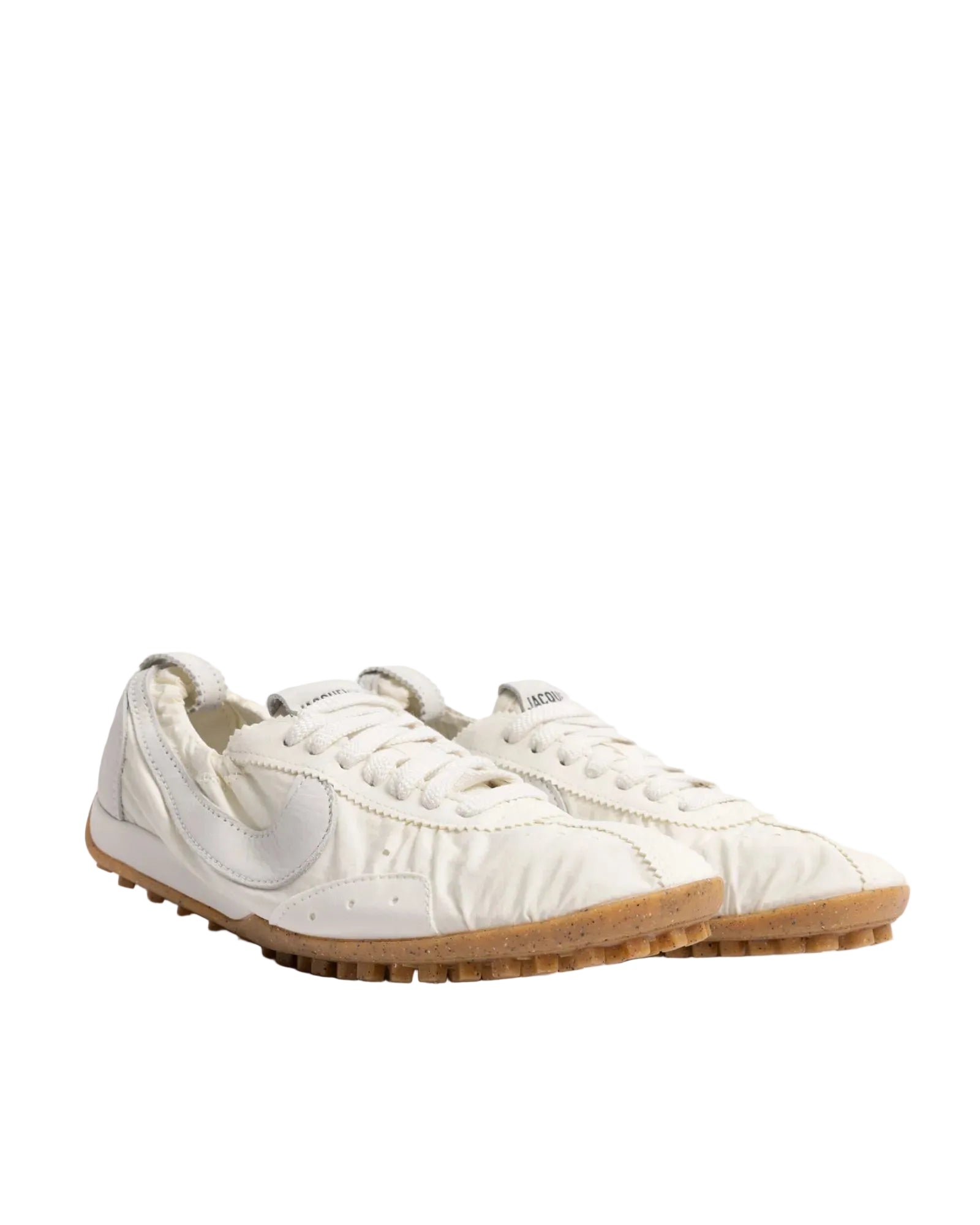 White sneakers with a brand logo on a white background