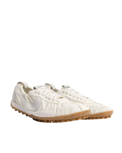 White sneakers with a brand logo on a white background