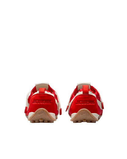 Red shoes with a brand logo on a white background
