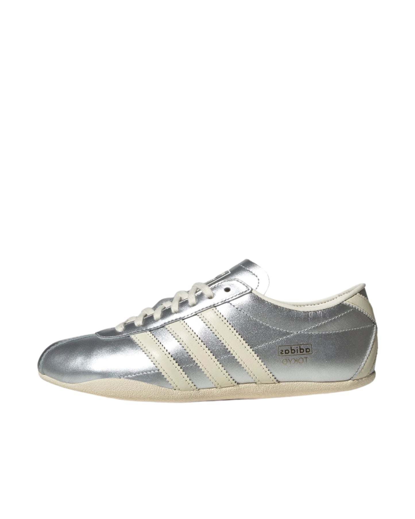 Silver Adidas sneaker with white stripes on a white background