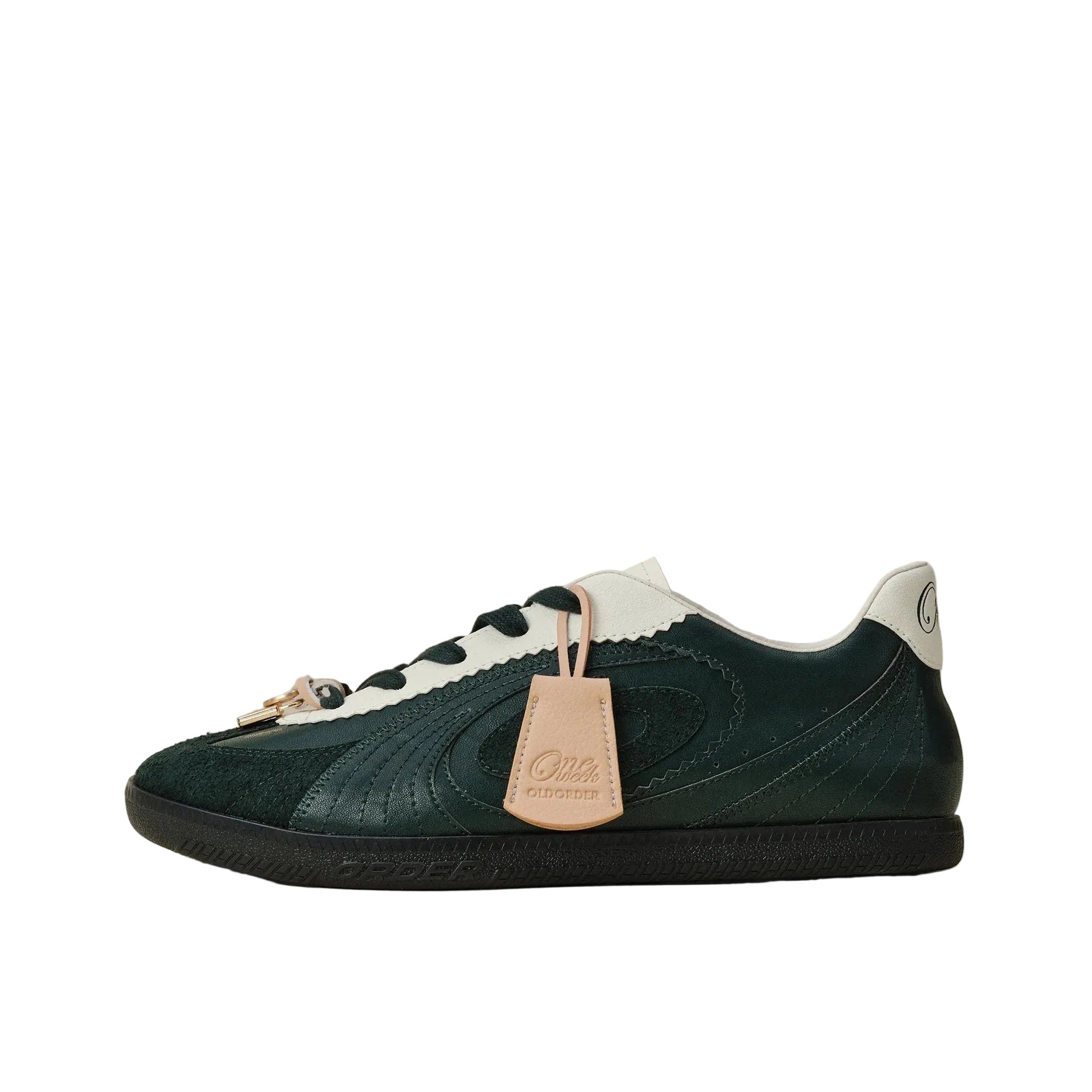 A Gucci low-top sneaker in dark forest green suede and textured leather, featuring white leather overlays, a black rubber sole, a gold-tone horsebit detail on the laces, and a beige leather hangtag.