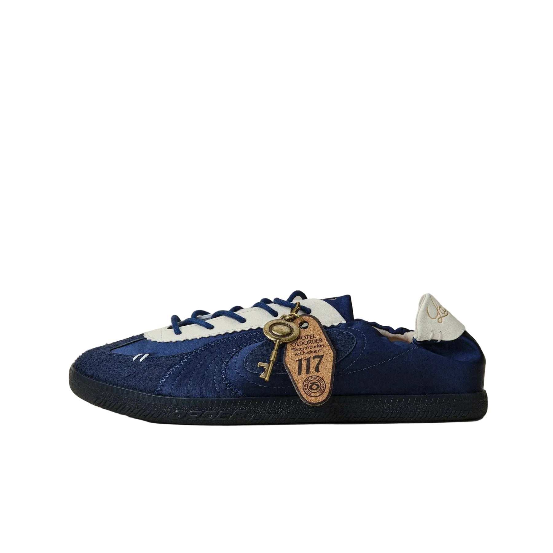 Blue sneaker with a keychain on a beige background