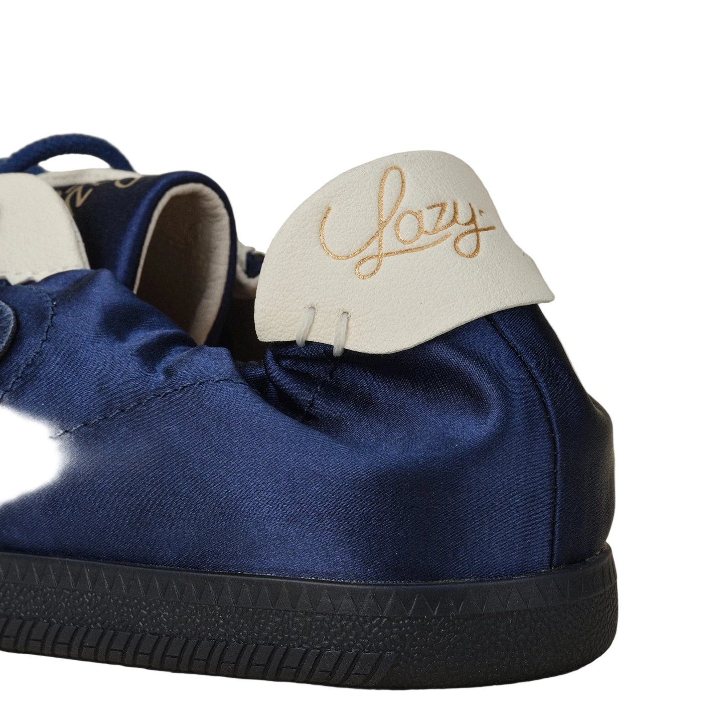 Blue satin shoe with white insole and 'Lazy' embroidery on a neutral background