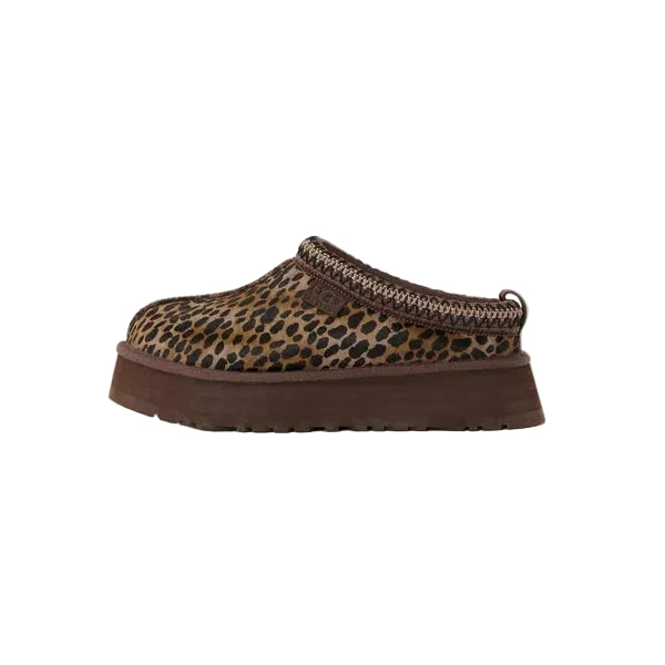Leopard print slip-on shoe with brown sole on a light gray background