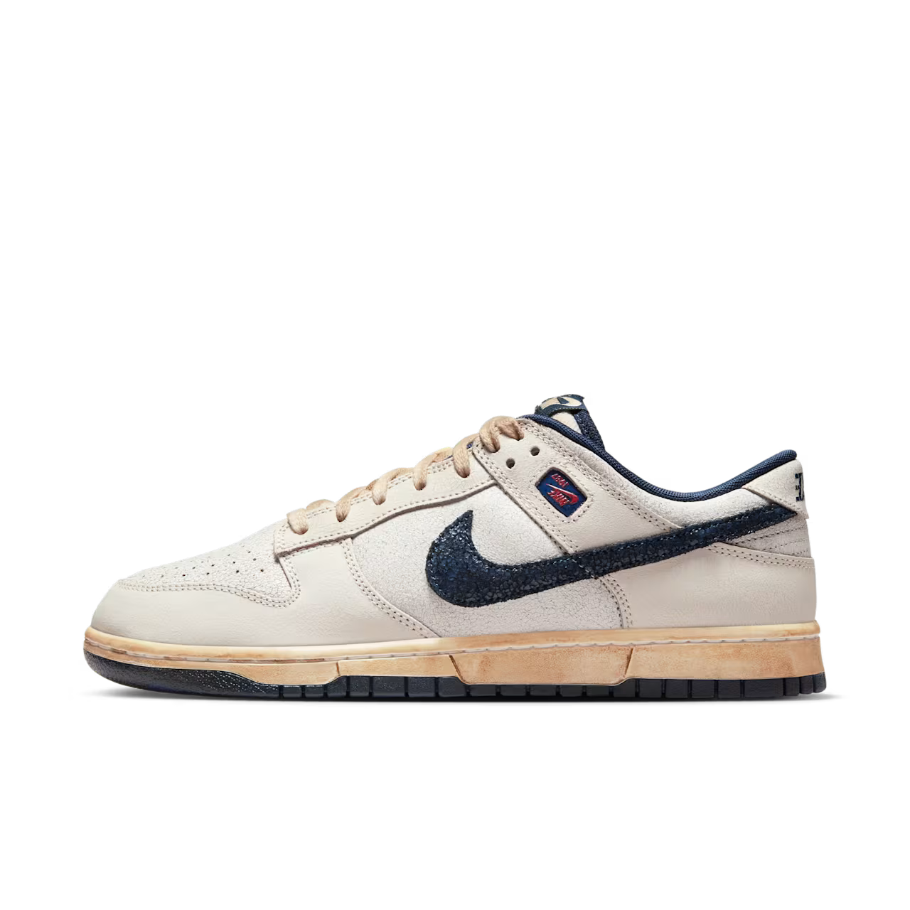 Beige sneaker with navy swoosh logo on a white background